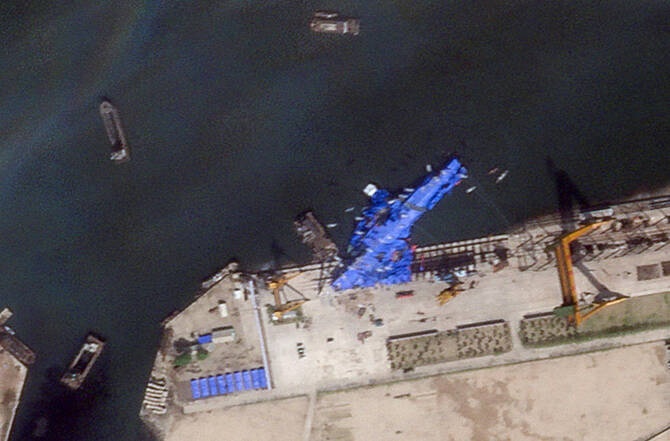 A satellite image shows a North Korean warship covered with a blue tarp after an accident that occurred during its launch at the shipyard in Chongjin, North Korea on May 23, 2025. (Planet Labs PBC via Reuters)