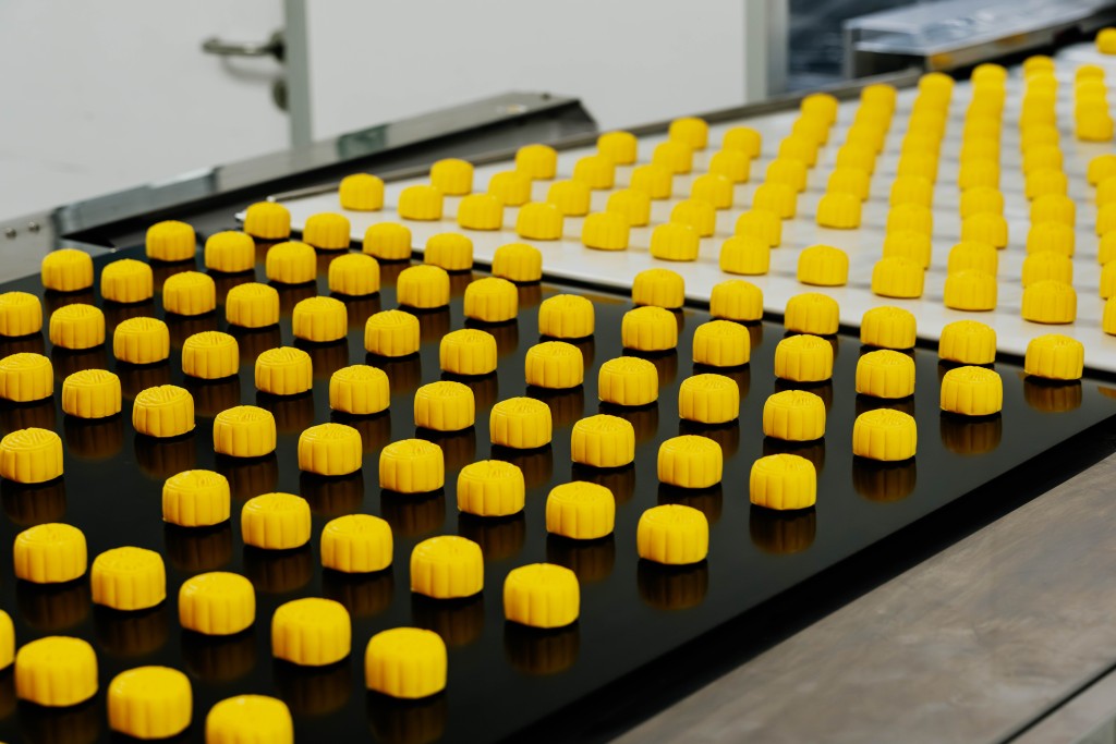Mooncakes move along the production line before entering the oven for baking.