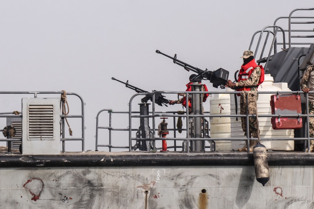 Sailors from the navy of Yemen's Aden-based internationally recognised government stand at machine-gun positions aboard a vessel patrolling a shipping lane off Hanish Island in the Red Sea on July 27, 2026. AFP