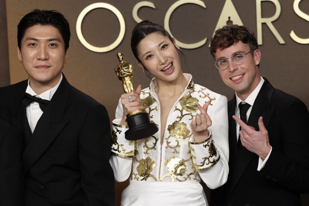 Jeong Hoon Seo, South Korean-US singer Ejae, US songwriter Mark Sonnenblick pose in the press room with the Oscar for Best Music (Original Song) for "Golden" from "KPop Demon Hunters" during the 98th Annual Academy Awards at the Dolby Theatre in Hollywood, California on March 15, 2026. (AFP)