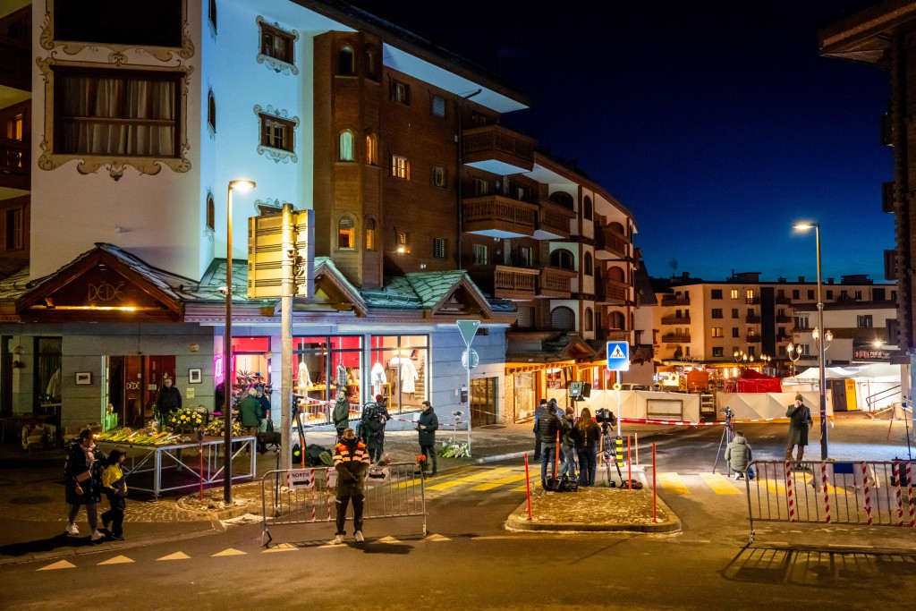 Journalists gather in front of the street where a fire ripped through a crowded bar during New Year's Eve celebrations in the Alpine ski resort town of Crans-Montana on January 1, 2026. (AFP)