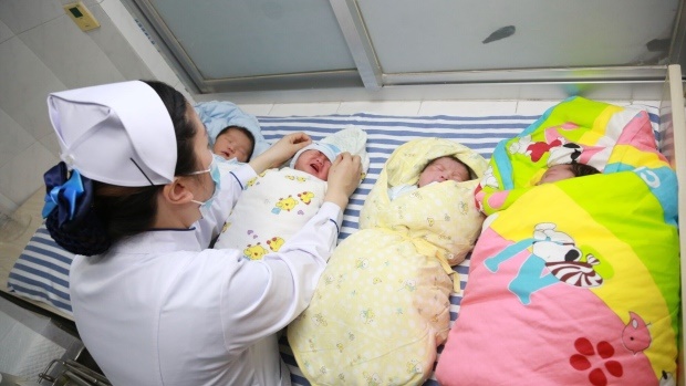 A nurse takes care of newborn babies at a hospital in Hubei Province of China. Photographer: Gong Bo/Visual China Group/Getty Images , Photographer: VCG/Visual China Group via Bloomberg A nurse takes care of newborn babies at a hospital in Hubei Province of China. Photographer: Gong Bo/Visual China Group/Getty Images , Photographer: VCG/Visual China Group via Bloomberg