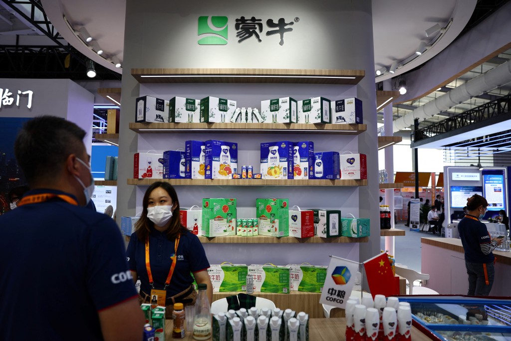 Staff members stand at a booth of Mengniu Dairy during the 2022 China International Fair for Trade in Services (CIFTIS) in Beijing, China September 1, 2022. REUTERS