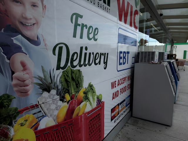 A sign for food stamps stands, as the U.S. President Donald Trump administration said it plans on Monday to partially fund food aid for millions of Americans after two judges ruled it must use contingency funds to pay for the benefits in November during the government shutdown, outside a grocery story in Baldwin, New York, U.S., November 3, 2025. REUTERS/Shannon Stapleton/File Photo