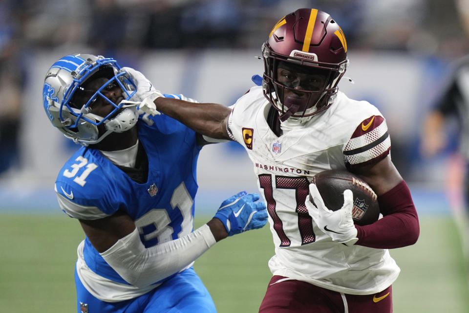 Washington Commanders wide receiver Terry McLaurin (17) stiff arms Detroit Lions safety Kerby Joseph (31) on a 58-yard touchdown reception during the first half of an NFL football divisional playoff game, Saturday, Jan. 18, 2025, in Detroit. (AP Photo/Seth Wenig)ASSOCIATED PRESS