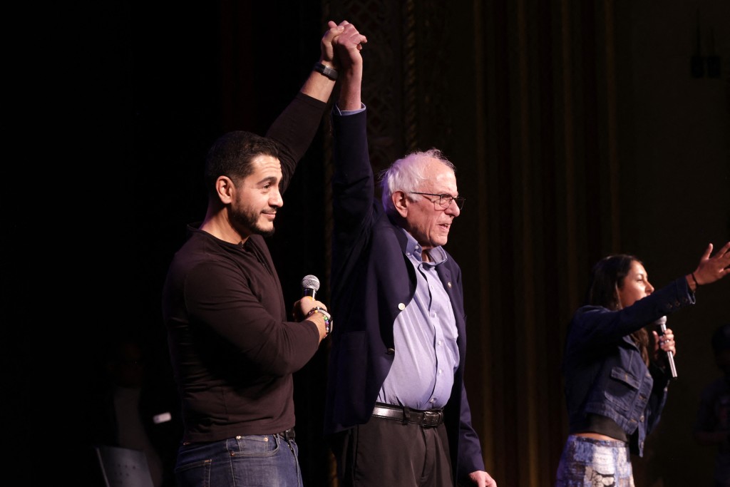 Democratic senatorial candidate for Michigan Abdul El-Sayed joins hands with US Senator Bernie Sanders (I-VT) at a More Perfect University Presents Students vs. Billionaires town hall at the Michigan Theater in Ann Arbor, Michigan, on October 26, 2026. (Photo by JEFF KOWALSKY / AFP)