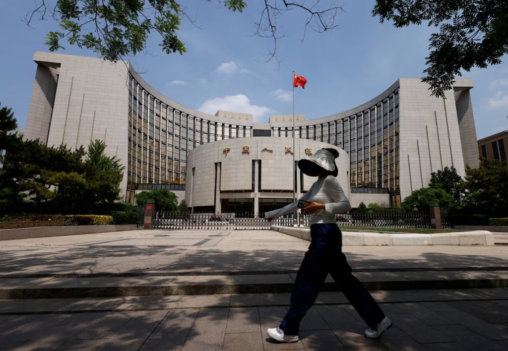 A person walks past the headquarters of the People's Bank of China, in Beijing, China May 7, 2025. REUTERS
