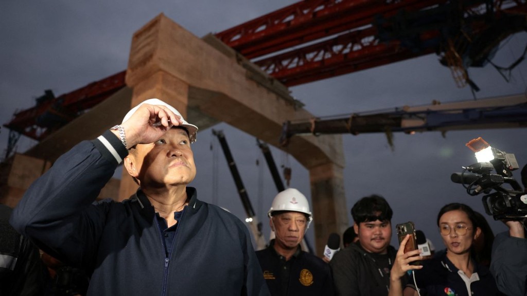 Thailand’s caretaker PM Anutin Charnvirakul visits the site where a train was derailed. Reuters