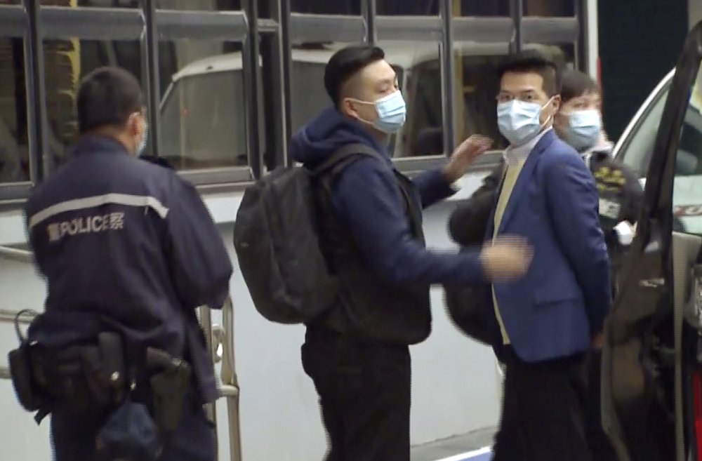 In this image taken from a video, former legislator and District Council member Gary Fan, right, is arrested at a police station today.