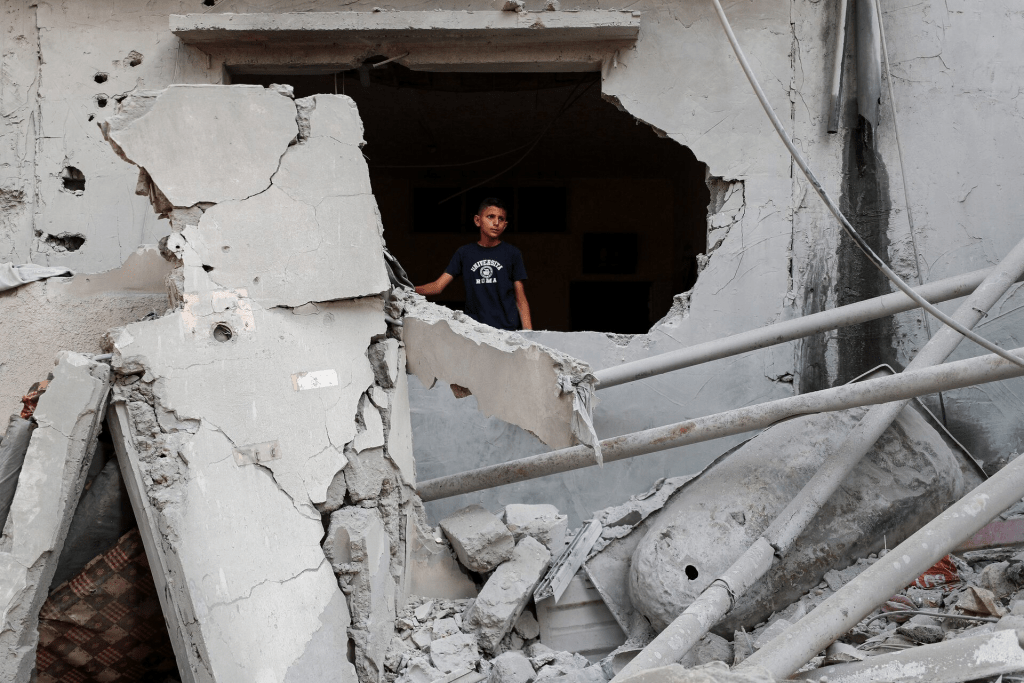 A Palestinian child stands at the site of an overnight Israeli air strike on a house, in Gaza City, July 11, 2025. REUTERS/Mahmoud Issa/File Photo 