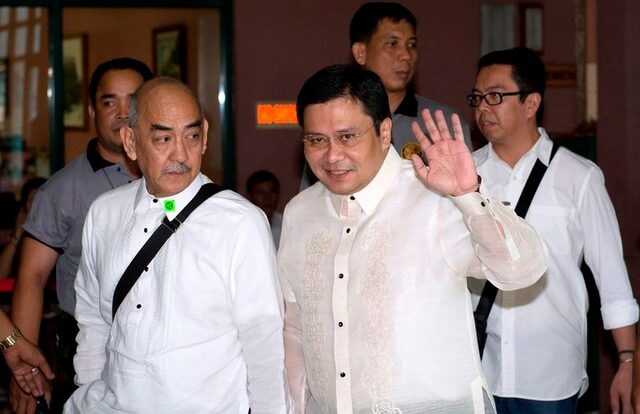 Senator Jose 'Jinggoy' Estrada (C), son of former Philippine President Joseph Estrada , waves as he arrives at the graft court for his arraignment in Manila June 30, 2014. REUTERS/Noel Celis/Pool