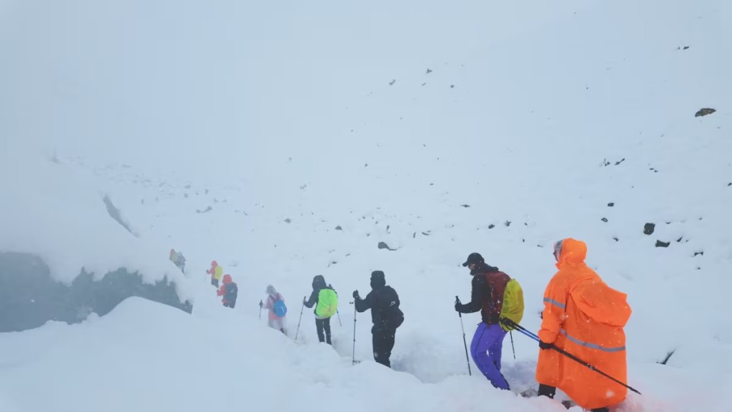  A screen capture from video shows trekkers leaving their campsite, as unusually heavy snow and rainfall pummeled the Himalayas, in the Tibet Region, China, October 5, 2025. Geshuang Chen/Handout via REUTERS