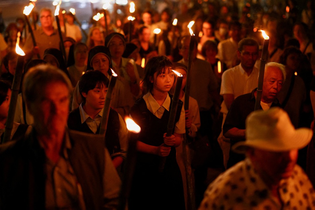 Catholics hold torches as they walk from Urakami Cathedral for a peace march to Hypocenter Park, on the 80th anniversary of the bombing of the city, in Nagasaki, southwestern Japan, August 9, 2025. REUTERS/Issei Kato 