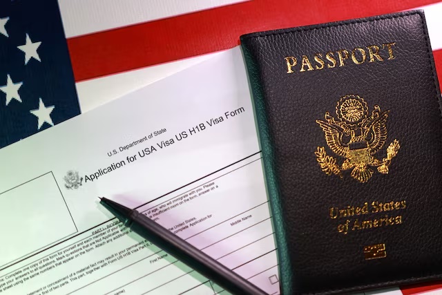 A U.S. flag, a passport and a U.S. H-1B Visa application form are seen in this illustration taken, September 22, 2025. REUTERS/Dado Ruvic/Illustration