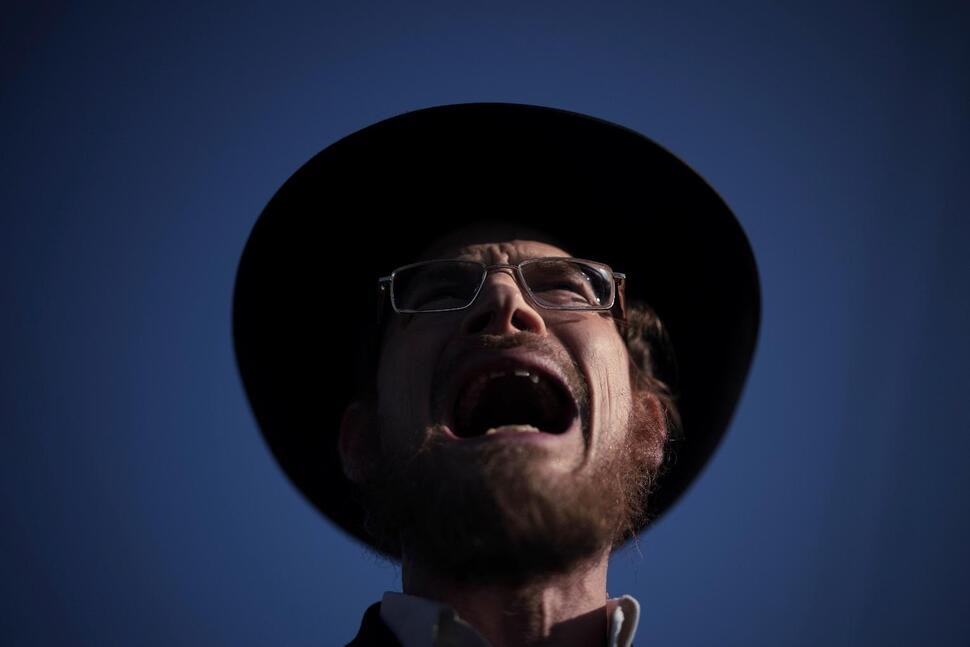 An ultra-Orthodox Jewish man shouts during a protest against army recruitment in Bnei Brak, Israel, Thursday, June 5, 2025. (AP Photo/Leo Correa)
