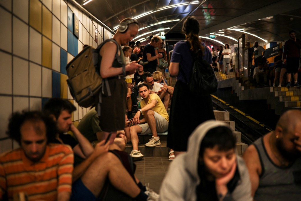 People take cover inside a cable car tunnel following a missile attack from Iran on Israel, at Haifa, Israel June 17, 2025. (Reuters)