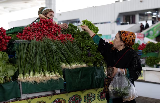 A woman buys vegetables at an open market in Ashgabat, Turkmenistan, March 17, 2026. REUTERS/Umit Bektas 