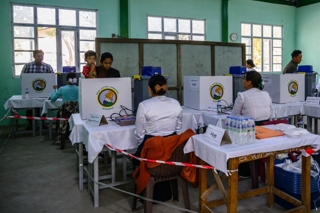 Voters cast their ballots at a polling station during the third and final phase of Myanmar's general election in Mandalay on January 25, 2026. (AFP)