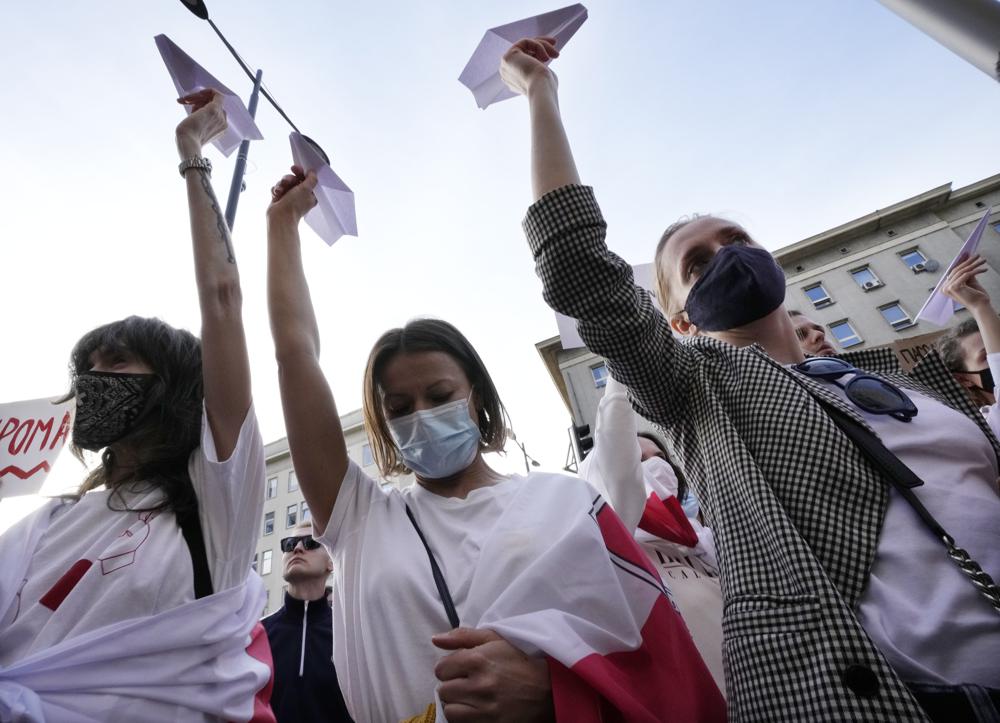 Protesters hold up paper planes during a demonstration of Belarusians living in Poland and Poles supporting them in front of European Commission office in Warsaw demanding freedom for Belarus opposition activist Raman Protasevich in Warsaw, Poland, Monday, May 24, 2021 Protesters hold up paper planes during a demonstration of Belarusians living in Poland and Poles supporting them in front of European Commission office in Warsaw demanding freedom for Belarus opposition activist Raman Protasevich in Warsaw, Poland, Monday, May 24, 2021