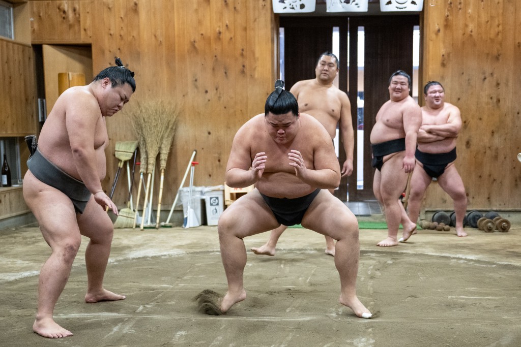Photo by MATHIAS CENA / AFP  This picture taken on January 8, 2026 shows sumo wrestlers taking part in the morning practice at the Kise sumo stable in Tokyo.