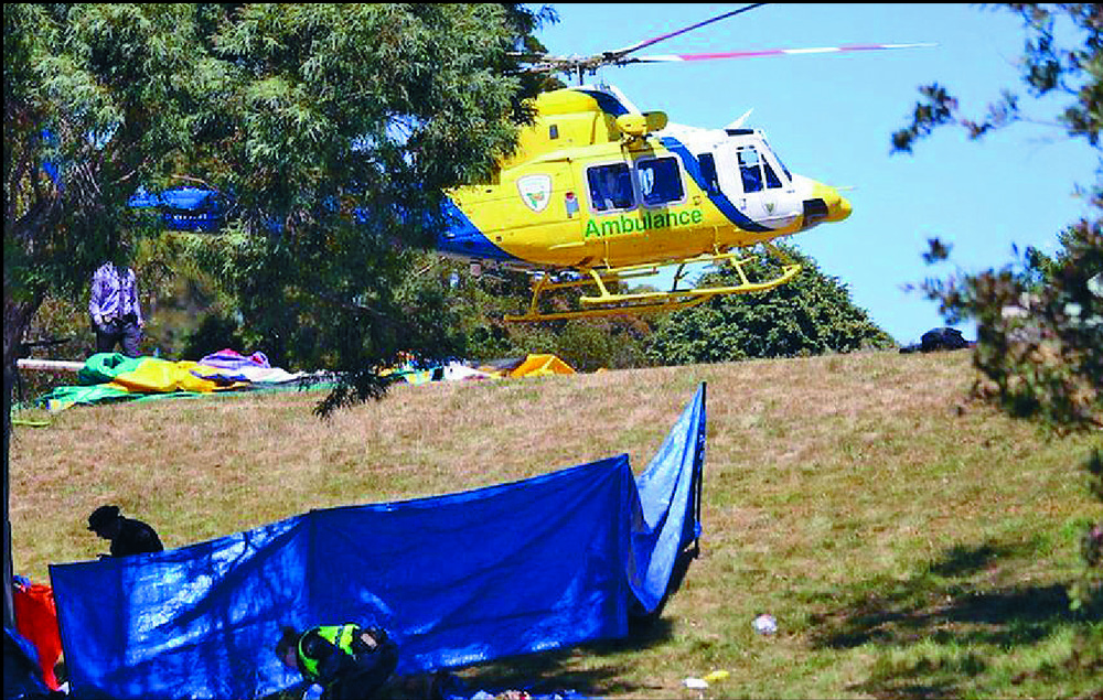 Emergency services personnel work on the scene of the deadly incident involving a bouncy castle blown away by gusts of wind in Devonport, Tasmania. Blue tarpaulin sheets shield what officers describe as 'a very confronting and distressing scene.' AP Emergency services personnel work on the scene of the deadly incident involving a bouncy castle blown away by gusts of wind in Devonport, Tasmania. Blue tarpaulin sheets shield what officers describe as 'a very confronting and distressing scene.' AP
