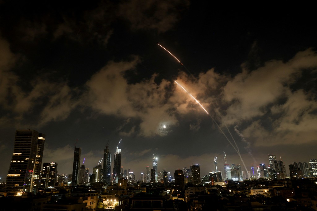 An anti-missile system operates as missiles are launched from Iran, as seen from Tel Aviv, Israel, June 18, 2025. (Reuters)