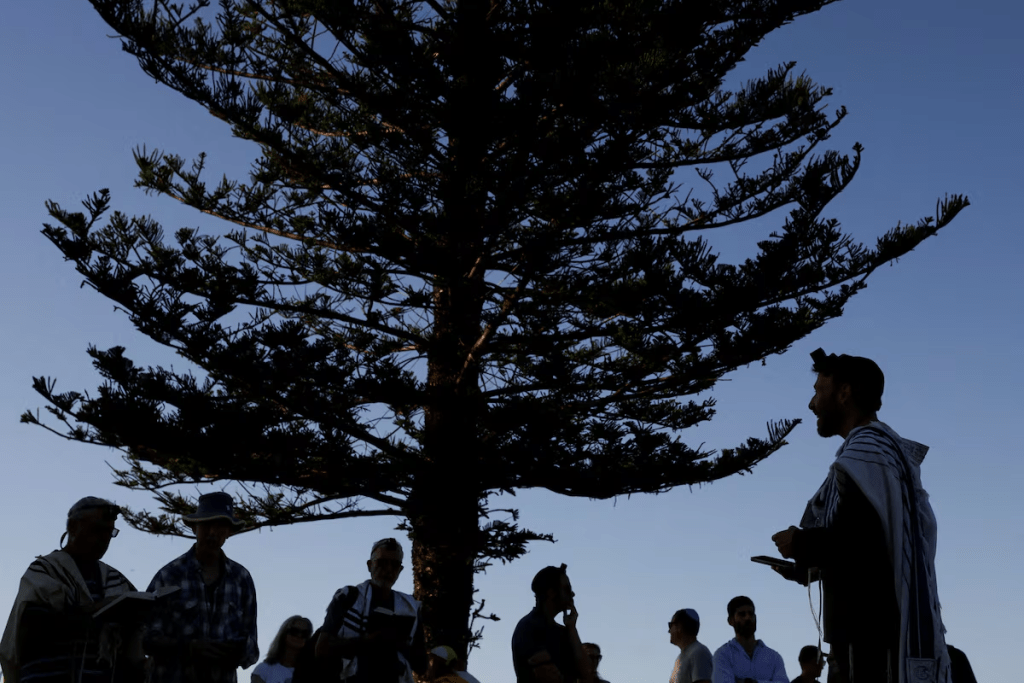 Members of the Jewish community gather for Shacharit, morning prayers, as the crime scene was reopened following the mass shooting at Bondi Beach on Sunday, in Sydney, Australia, December 19, 2025. REUTERS/Hollie Adams/File Photo