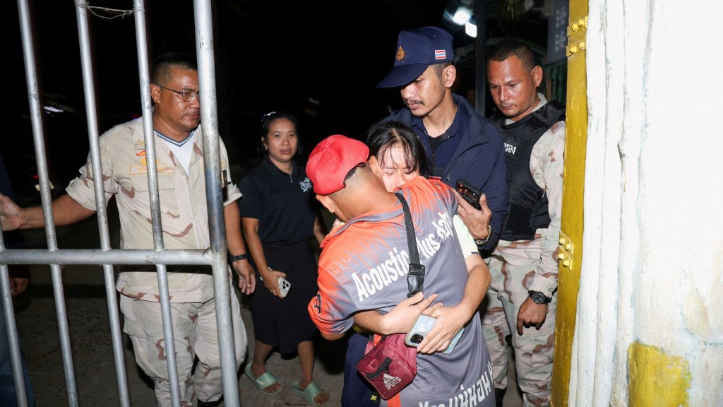 A girl reacts as she reunites with her family after being evacuated from Patongprathankiriwat School. Reuters