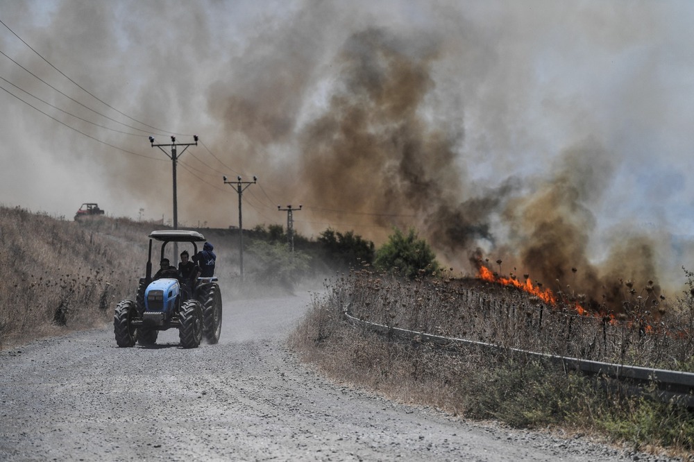 Fires blaze near a road, after Lebanon's Hezbollah said it launched more than 200 rockets and a swarm of drones at Israeli military sites, in the Israeli-occupied Golan Heights. (Reuters) Fires blaze near a road, after Lebanon's Hezbollah said it launched more than 200 rockets and a swarm of drones at Israeli military sites, in the Israeli-occupied Golan Heights. (Reuters)
