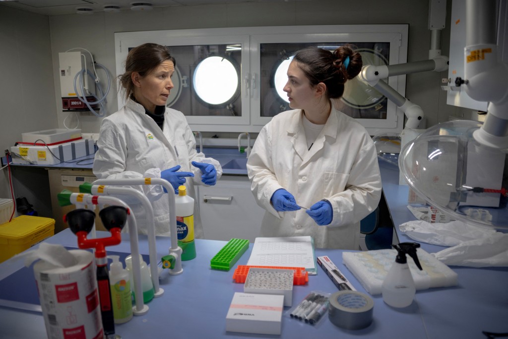 Photo by OLIVIER MORIN / AFP  Belgian toxicologist Laura Pirard (R), who specialises in marine mammals, tests the ‘Slice’ method on polar bear adipose tissue biopsies, with Finnnish toxicologist specialising in marine mammals, Heli Routti (L), in a laboratory onboard the science icebreaking vessel 'Kronprins Haakon' while sailing in eastern Spitzbergen, in the Svalbard archipelago, on April 6, 2025.