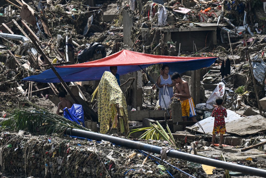 Residents rebuild houses in the aftermath of Typhoon Kalmaegi in Talisay, in the province of Cebu on November 5, 2025. (Photo by Jam STA ROSA / AFP)