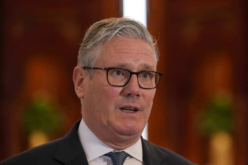 Britain's Prime Minister Keir Starmer speaks to the media at the airport in Doha, Qatar on April 10, 2026. (Photo by Alastair Grant / POOL / AFP)