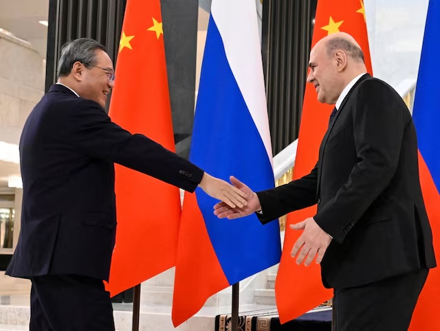 Russian Prime Minister Mikhail Mishustin shakes hands with Chinese Premier Li Qiang before a meeting on the sidelines of the Council of Heads of Government of the Shanghai Cooperation Organisation (SCO) member states in Moscow, Russia November 17, 2025. Sputnik/Alexander Miridonov/Pool via REUTERS