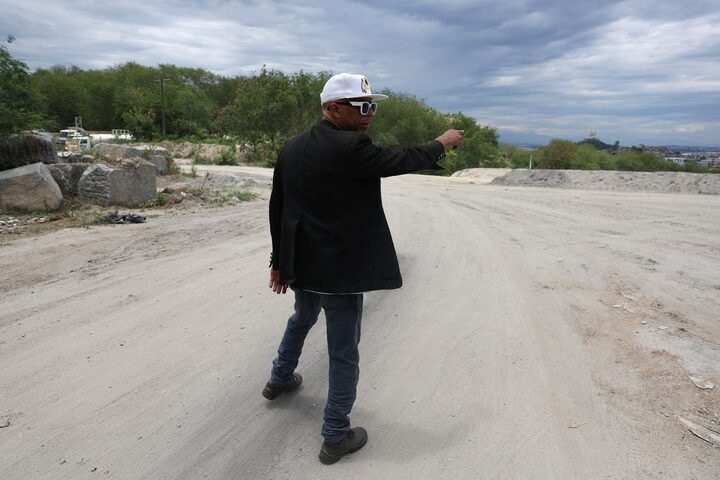 Wazen Ferreira, a local journalist of the Penha slum complex, points out at the place where Brazil’s police operation aimed to neutralize the local leadership of the Comando Vermelho gang last October. REUTERS/Pilar Olivares