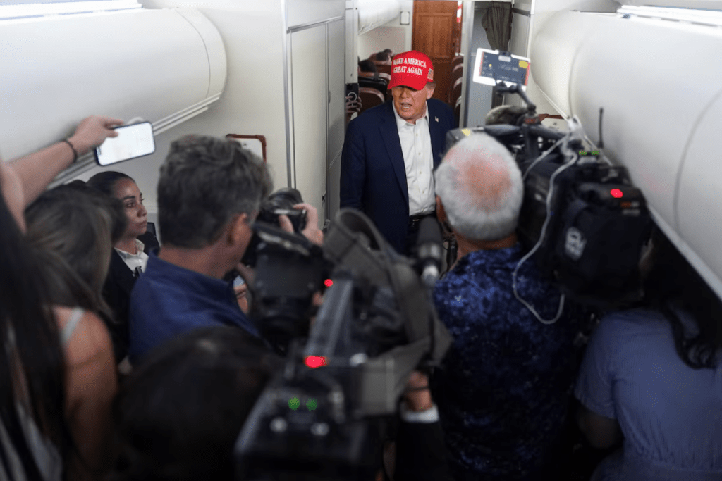 U.S. President Donald Trump speaks to members of the media on board Air Force One on the way to New Jersey, U.S., July 4, 2025. (REUTERS/Nathan Howard)