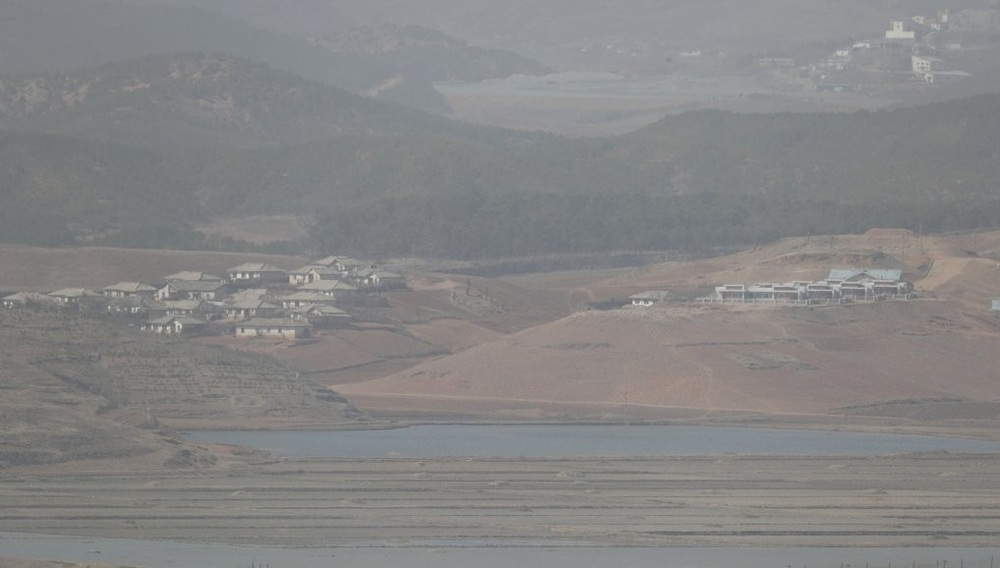 The North Korean western border county of Kaepung, observed from the South, looks blurred on March 16, 2021, as a powerful yellow dust storm from China is approaching the Korean Peninsula. The North Korean western border county of Kaepung, observed from the South, looks blurred on March 16, 2021, as a powerful yellow dust storm from China is approaching the Korean Peninsula.