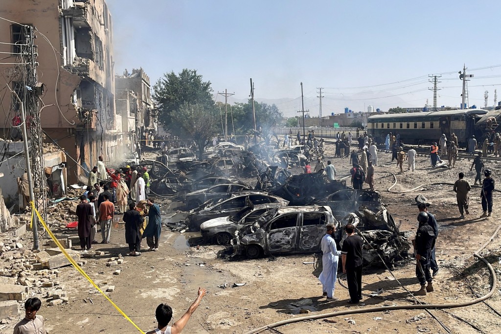 People and police officers gather after a blast near a railway track in Quetta, Pakistan, May 24, 2026. Picture taken with a mobile phone. (Reuters)