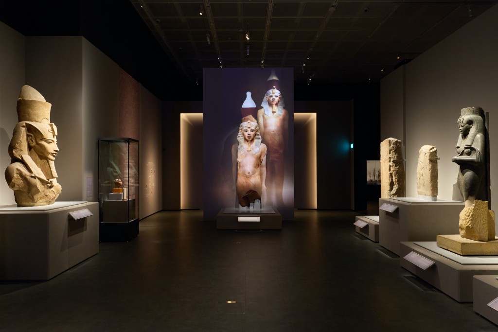 The museum uses projection mapping technology to virtually reconstruct the original appearance of the colossal statue of Tutankhamun (center).
