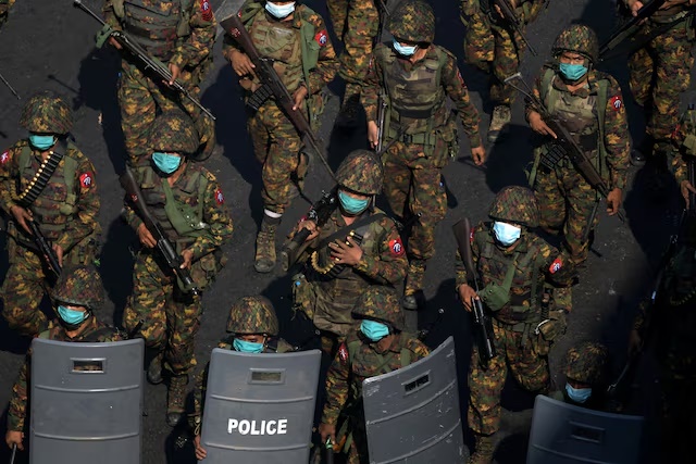 Myanmar soldiers from the 77th light infantry division walk along a street during a protest against the military coup in Yangon, Myanmar, February 28, 2021. Picture taken February 28, 2021. REUTERS/Stringer/File Photo