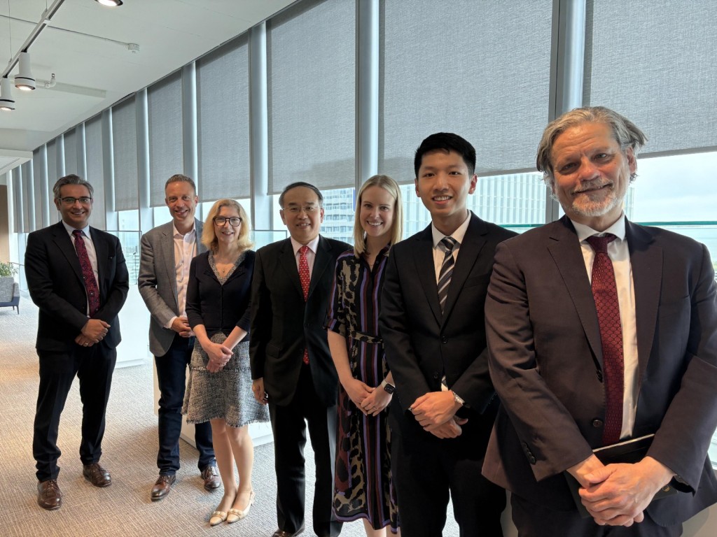 Christopher Hui, center, with Sun Life executive vice-president and chief financial officer Tim Deacon, second left, executive vice-president and chief strategy and enablement officer, Linda Dougherty, third left, and other representatives of the company, as well as the acting director of the Hong Kong Economic and Trade Office (Toronto) Gavin Yeung, second right.