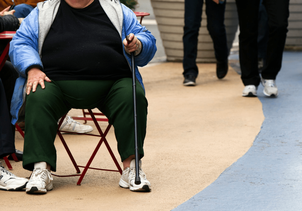 An overweight woman sits on a chair in Times Square in New York, May 8, 2012. REUTERS/Lucas Jackson/File Photo