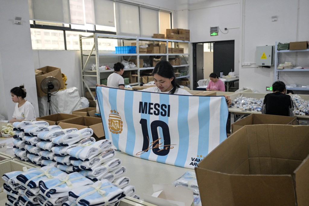 Photo by HECTOR RETAMAL / AFP In this photo taken on June 5, 2026, a worker packs merchandise of Lionel Messi of Argentina's national football team, which will participate in the FIFA World Cup 2026, at the All Star Partner factory in Yiwu in eastern China's Zhejiang province.