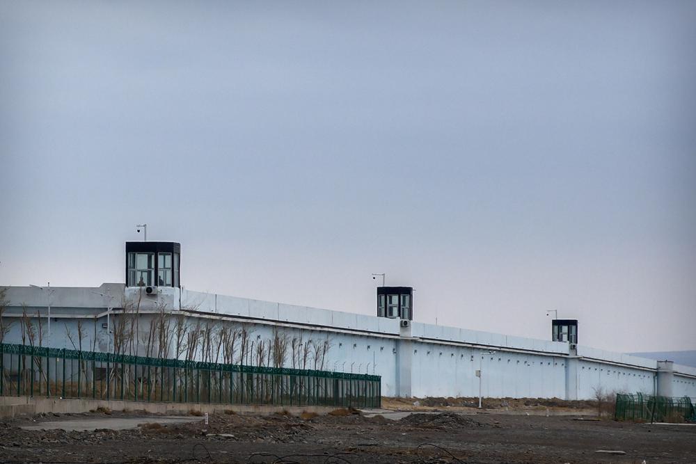People stand in a guard tower on the perimeter wall of the Urumqi No. 3 Detention Center in Dabancheng in western China's Xinjiang Uyghur Autonomous Region on April 23, 2021. China's largest detention center is twice the size of Vatican City and has room for at least 10,000 inmates.