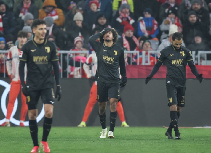 Han-Noah Massengo, center, celebrates scoring Augsburg's second goal against Bayern Munich. AFP