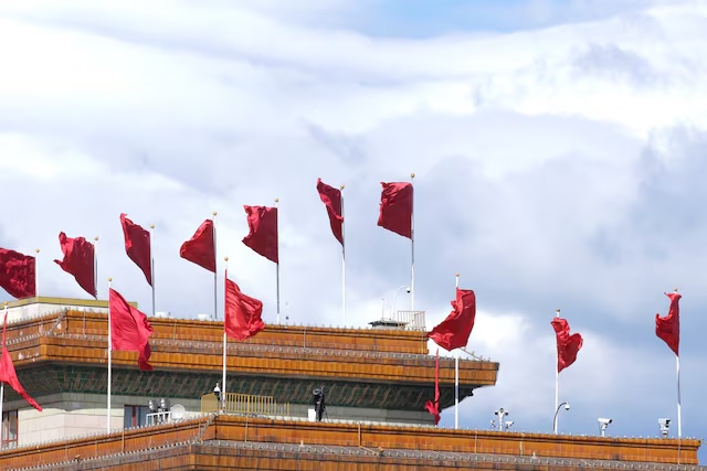 Red flags flutter on the top of the Great Hall of the People in Beijing, China September 30, 2018. Picture taken September 30, 2018. REUTERS/Jason Lee 