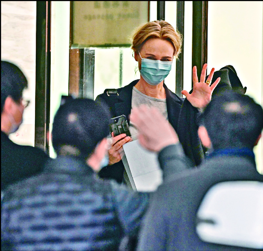 Thea Fischer waves to journalists before joining fellow WHO team members in departing the hotel where they were quarantined. AFP, AP Thea Fischer waves to journalists before joining fellow WHO team members in departing the hotel where they were quarantined. AFP, AP