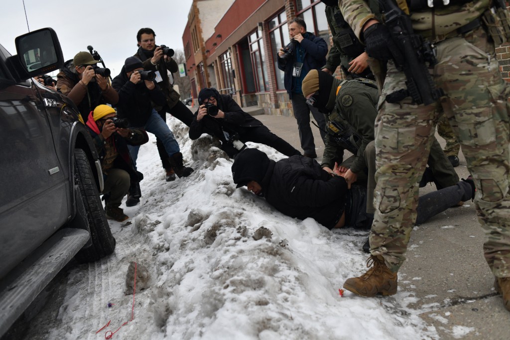 US Customs and Border Protection agents arrest a man after not providing documents proving he’s a citizen of the United States while patrolling a neighborhood during immigration enforcement activity in Minneapolis in Minneapolis, Minnesota, on January 11, 2026. (AFP)