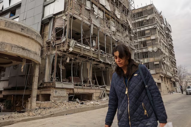 A woman walks on the street following an airstrike in Tehran, Iran, March 2. Majid Asgaripour/WANA