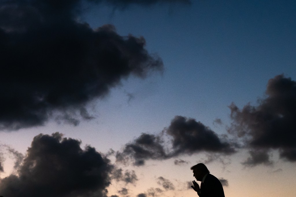 U.S. President Donald Trump waves while exiting Air Force One at Palm Beach International Airport on March 27, 2026 in West Palm Beach, Florida. President Trump will spend the weekend at his Mar-a-Lago resort in Florida. Nathan Howard/Getty Images/AFP