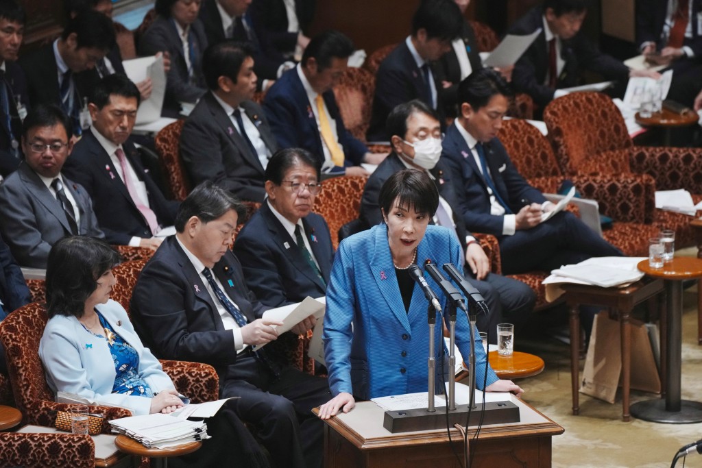 Japan's Prime Minister Sanae Takaichi (C) answers a question during a session of the House of Councillors Budget Committee at the National Diet in Tokyo on November 12, 2025.